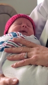 Erlanger Baroness Hospital – Baby Adelle Faulkner sleeps comfortably in Dr. Leslie Griffin’s arms after receiving her red hat from UT Family Practice at Erlanger.